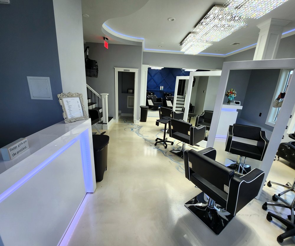 A Hair Story Salon reception area with LED edged desk and salon menu
